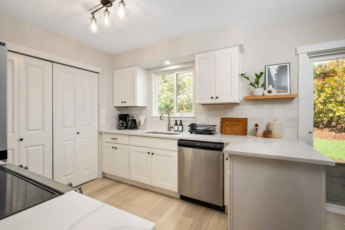 A spacious, upgraded kitchen with a central island, modern appliances, and plenty of natural light, ideal for group cooking and entertainment before heading out for local excursions.